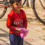 Cute Poor Child on City Street